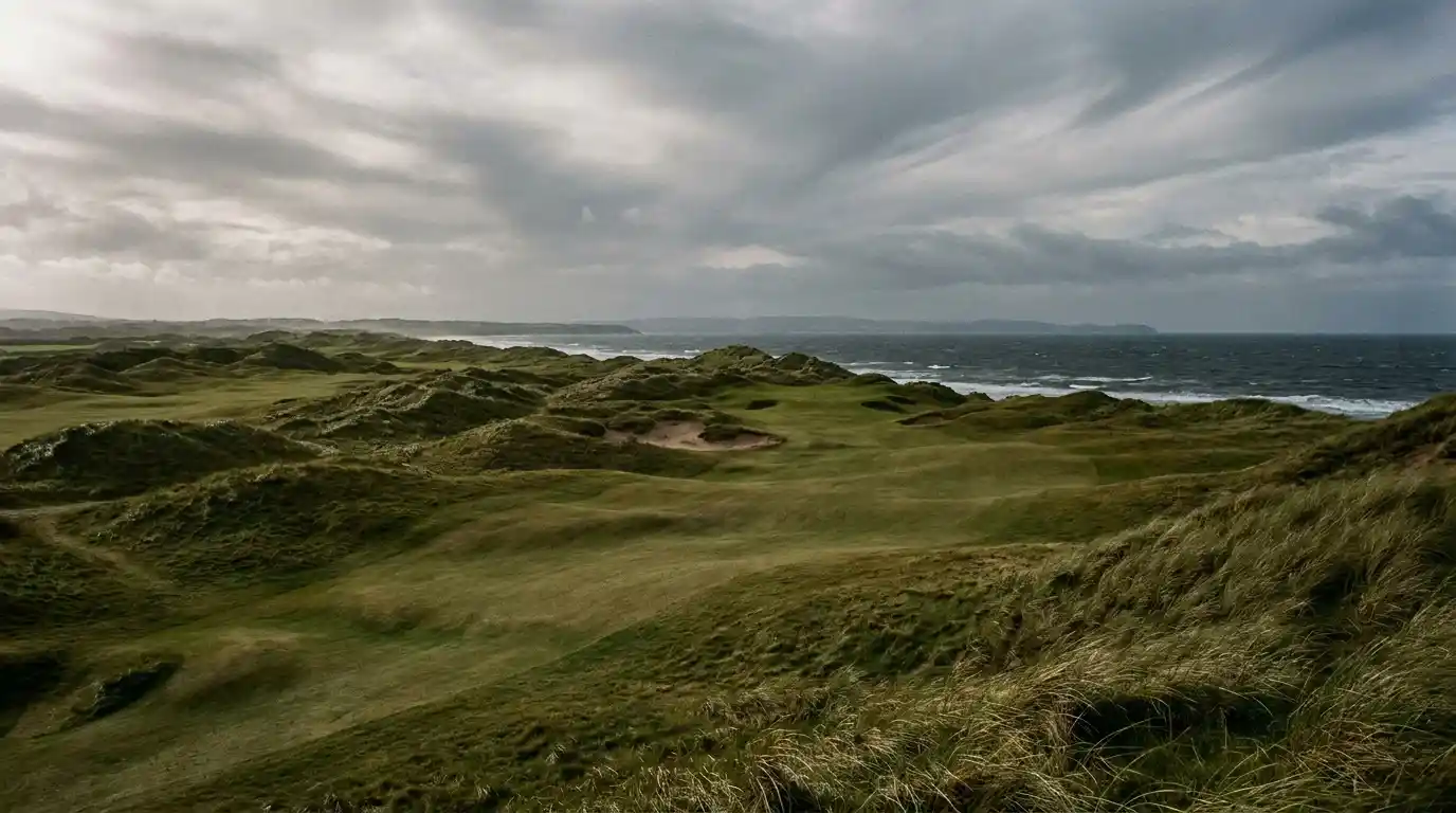 Classic British links golf course at The Open Championship with dramatic coastal sky
