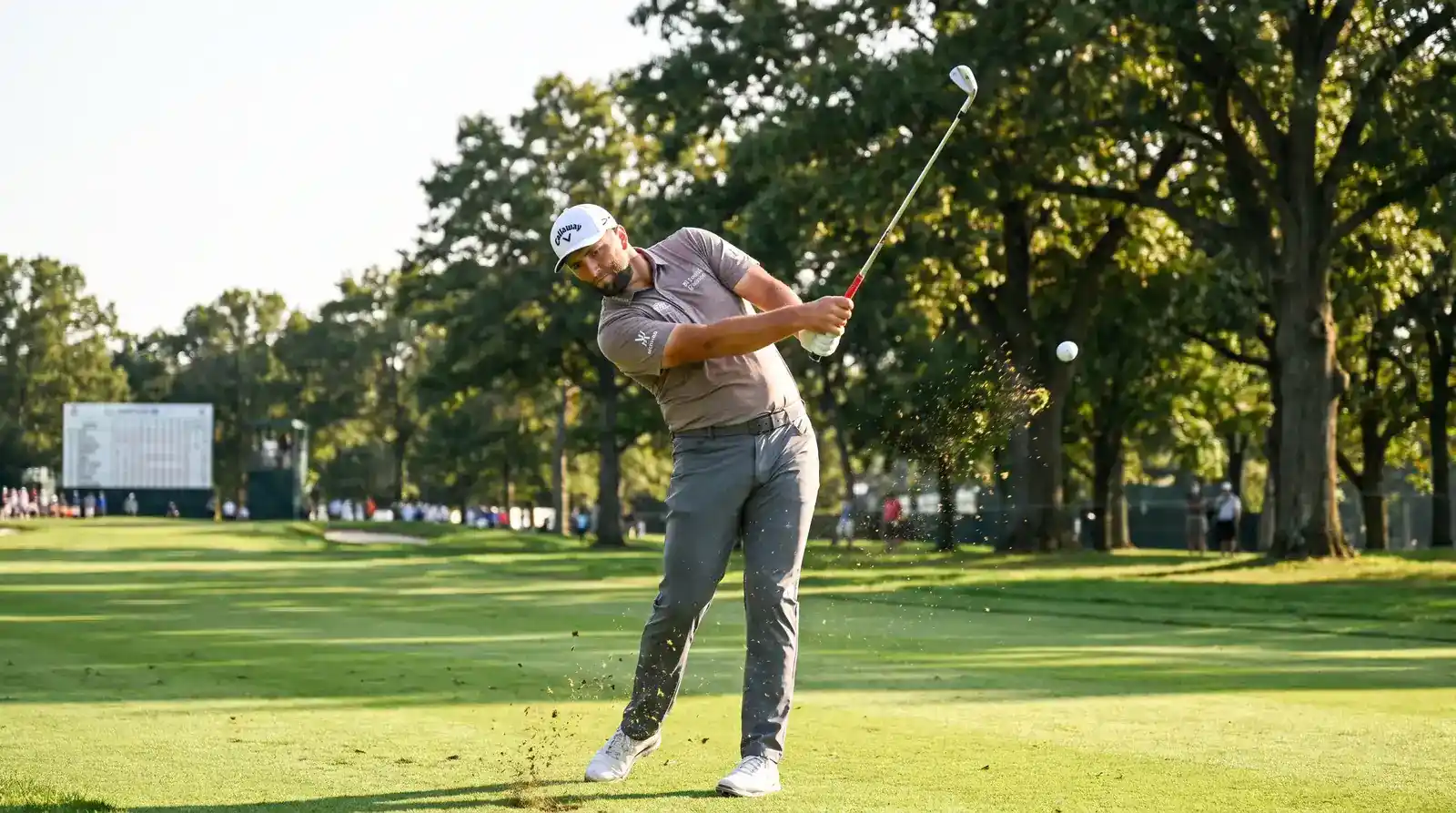 Golf analyst reviewing SG data on a tablet to identify top-20 finish candidates